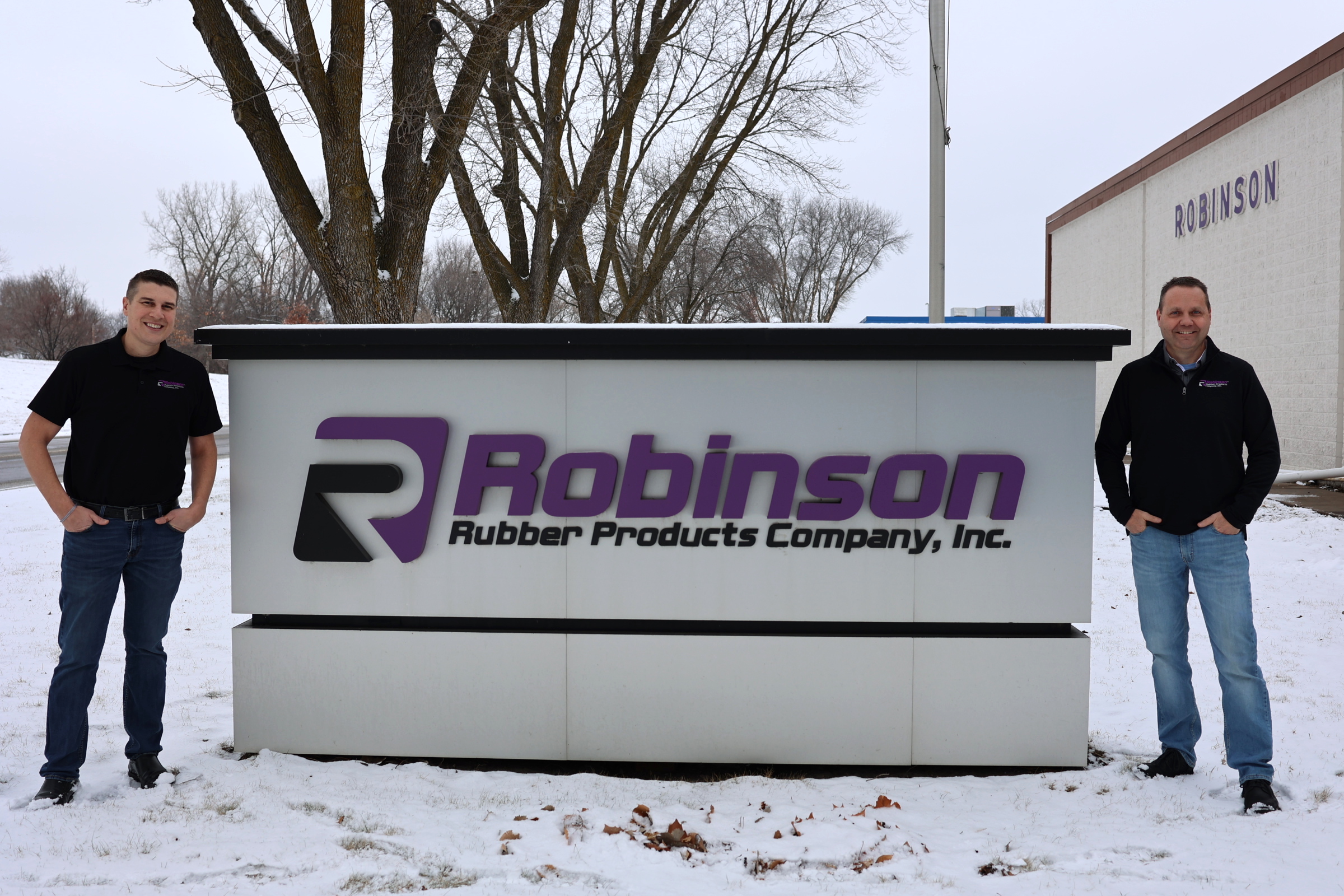 Owner Pete Wolf next to Robinson Rubber sign
